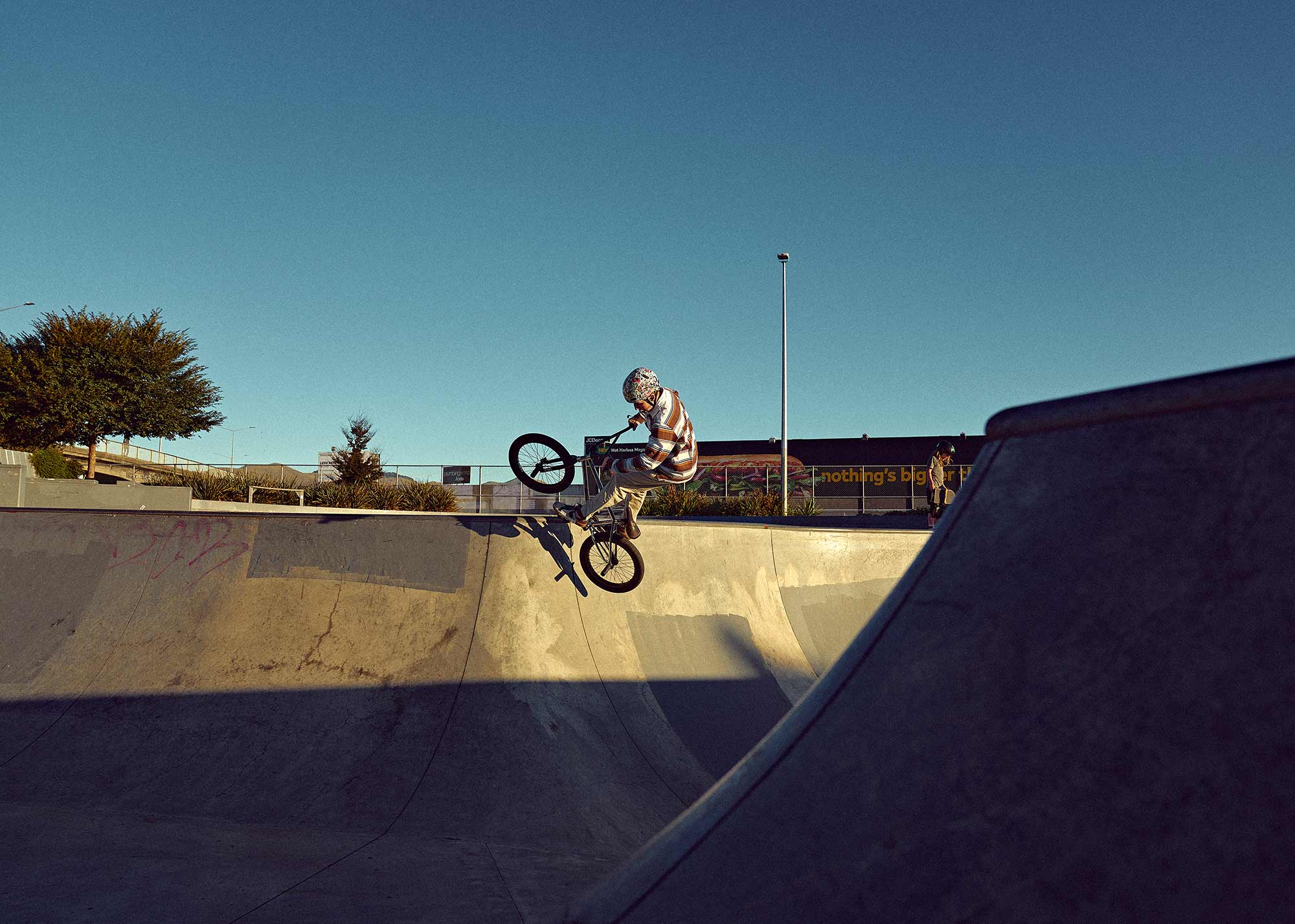 Vibrant Cycling scene at Washington Skatepark, Christchurch, showcasing a lively community of skaters and bikers