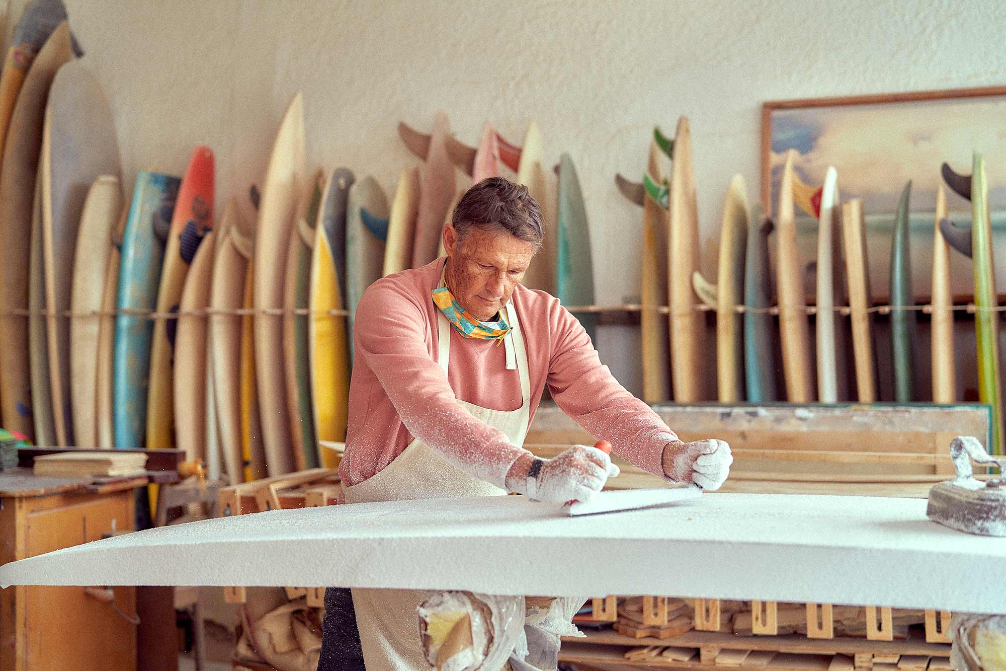 Lifestyle photoshoot featuring WAWA, a surfboard shaping company. The image captures the essence of the lifestyle associated with WAWA, showcasing the craftsmanship and passion for surfboard shaping. Surrounded by surfboards and tools, the photograph exudes a sense of creativity and adventure.