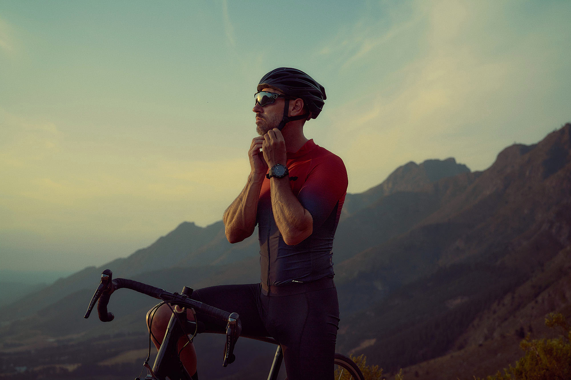 photograph carefully emphasises the exquisite details and craftsmanship of the Tissot T-Touch Connect watch. Lifestyle product photography highlights the synergy between the cyclist and the mountain range.