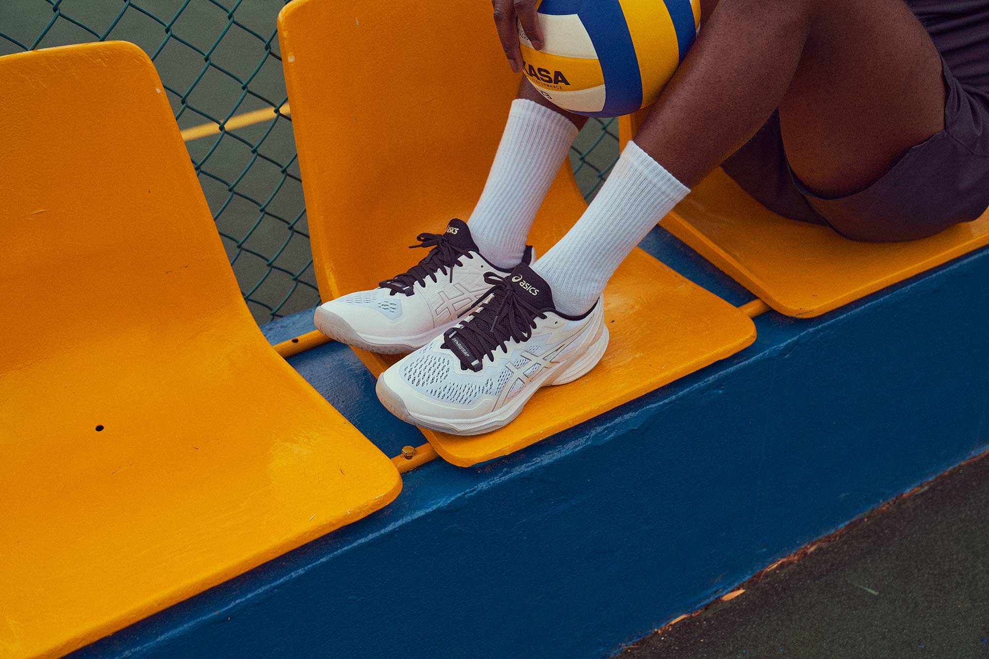 Close-up shot of ASICS Volleyball shoes, photographed for ASICS Europe on yellow chairs